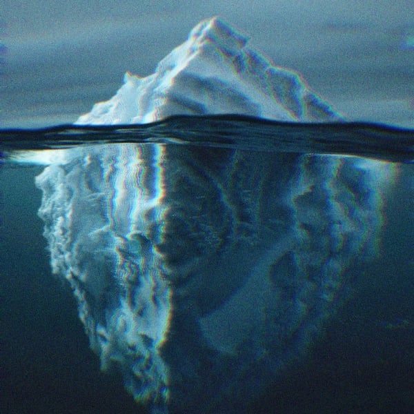 An iceberg visible above and below the water.