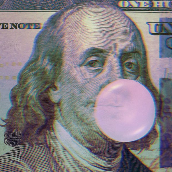 Benjamin Franklin on the hundred dollar bill blowing a bubblegum bubble.