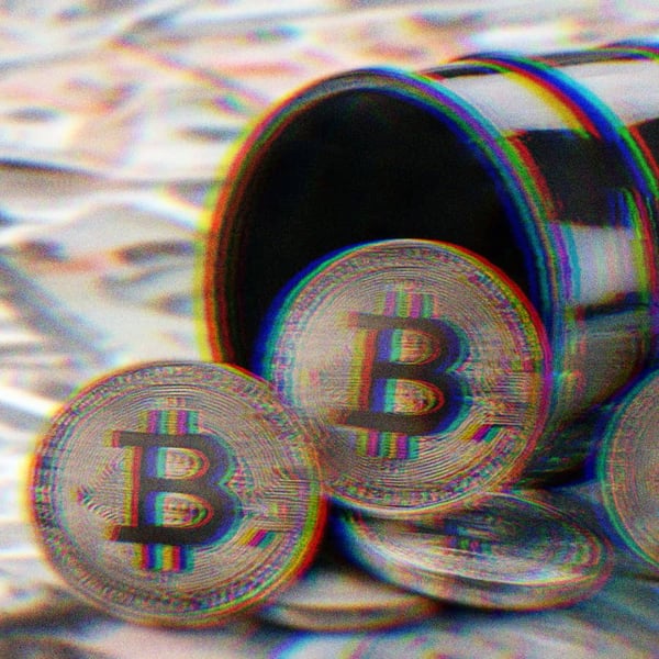 Bitcoins spilling out of an oil barrel