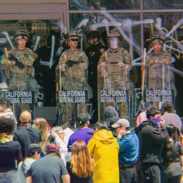 California National Guard standing in front of a group of protesters.