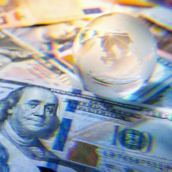 Crystal globe on top of currency from around the world.