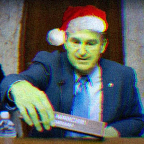 Image of Joe Manchin wearing a santa hat with green skin, making him look like the Grinch.