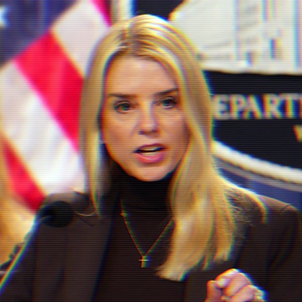 Pam Bondi Speaking at a podium, there is a Department of Justice Sign behind her.