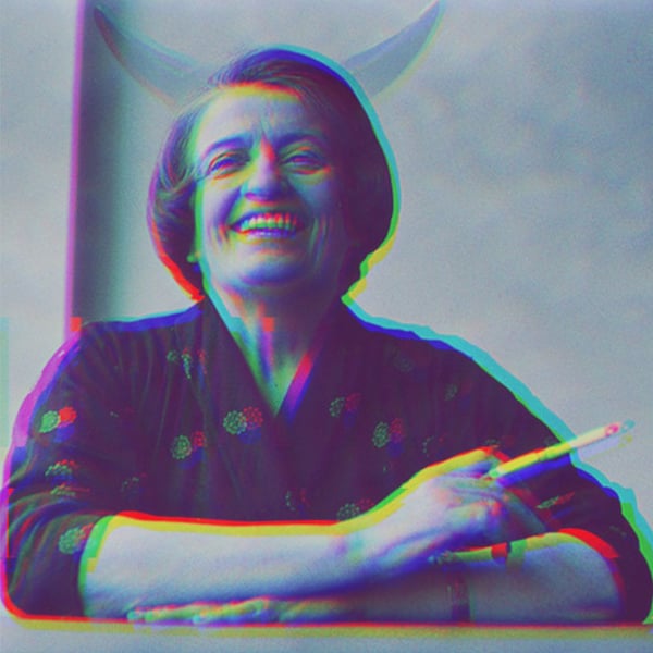 Ayn Rand smoking and laughing.