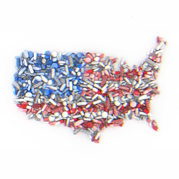 Pills in the shape of the United States, colored like the American Flag.
