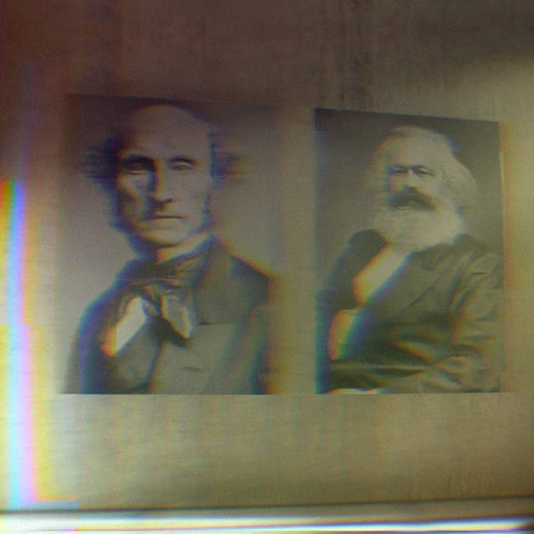 Portraits of Karl Marx and John Stuart Mill in a gallery.