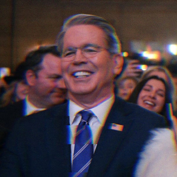 Scott Bessent sitting next to Nicki Minaj. The pair are laughing.