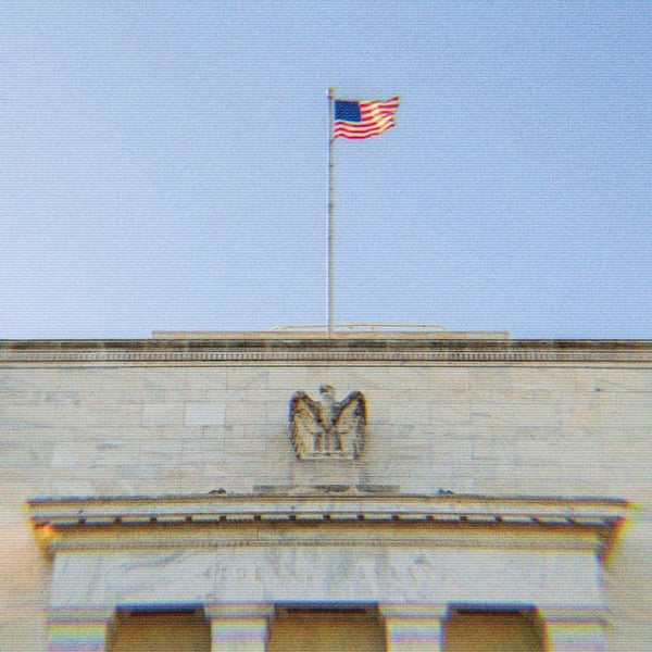 The Federal Reserve building. The words ‘Federal Reserve’ are visible, as is an eagle and the American Flag.