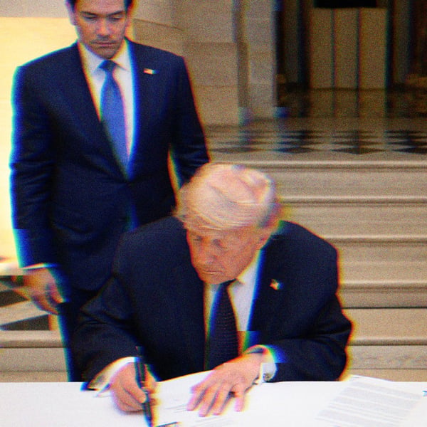 Trump signs the Memorandum of Understanding between Iran and the United States at the Palace of Versailles, France. Marco Rubio stands behind Trump, Emmanuel Macron is seated to his left.