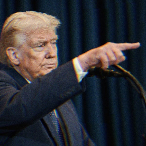 Trump speaking at a podium and pointing.