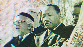 Martin Luther King, Jr. and Rabbi Abraham Joshua Heschel walking arm in arm. 