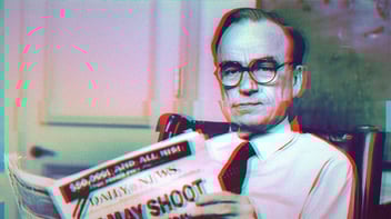 An old photo of Rupert Murdoch sitting in a chair holding a newspaper. A photo filter makes the image glitchy, with red and blue streaks clinging to the edges of Murdoch.