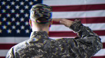 A U.S. solider saluting the American flag.