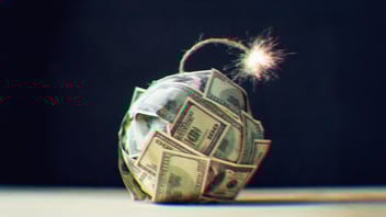 A ball of $100 bills with a lit fuse on the end.