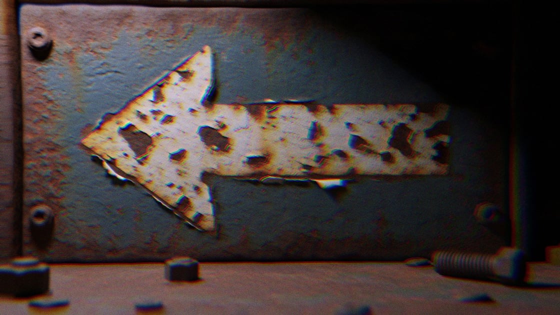 A grungy metal arrow pointing left
