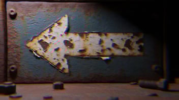 A grungy metal arrow pointing left.