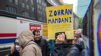 A protestor with a sign that says Zohran Mamdani, 2. Brad Lander, 3. Adrienne Adams, 4. Zellnor Myrie, Do Not Rank Cuomo, twice.