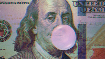 Benjamin Franklin on the hundred dollar bill blowing a bubblegum bubble.