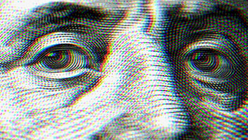 Close up of an $100 bill; Ben Franklin's eyes and nose are in frame.