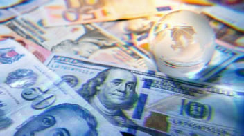 Crystal globe on top of currency from around the world.