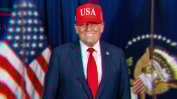Donald Trump smiling evilly wearing a red hat with USA in white letters.
