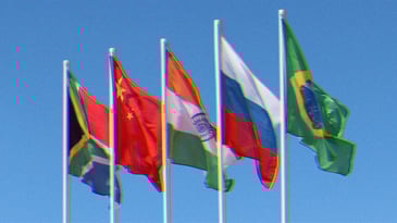 Founding BRICS nation flags waving in the air: South Africa, China, India, Russia and Brazil.