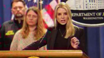 Pam Bondi Speaking at a podium, there is a Department of Justice Sign behind her.