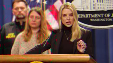 Pam Bondi Speaking at a podium, there is a Department of Justice Sign behind her.