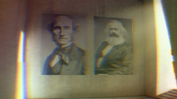 Portraits of Karl Marx and John Stuart Mill in a gallery.