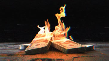 Stacks of $20 bills on fire.