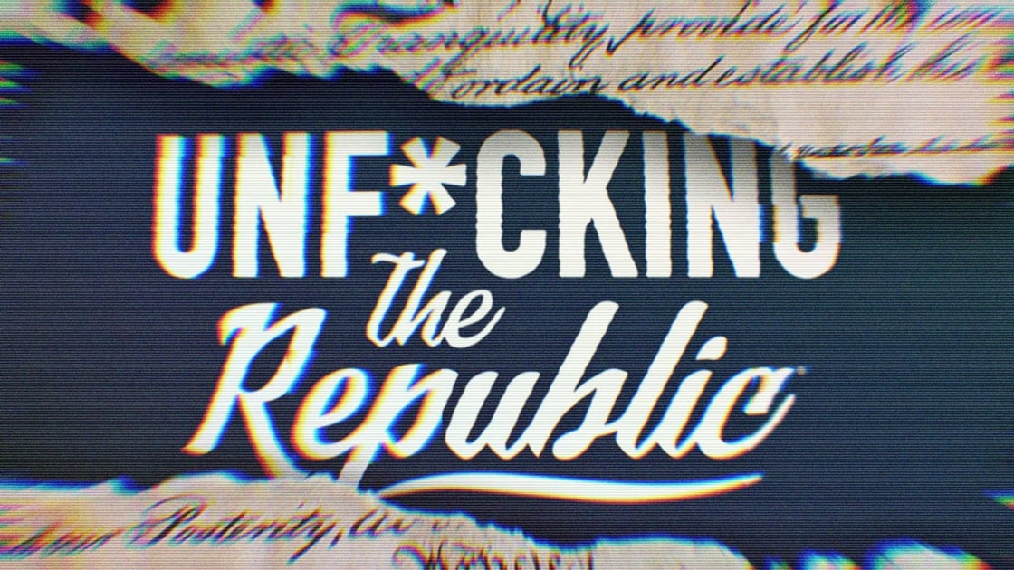 The US Constitution ripped in the middle revealing white text on a blue background that says, ‘Unf*cking the Republic.’ Letters have a glitchy rainbow effect on them.