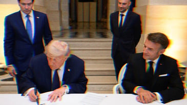 Trump signs the Memorandum of Understanding between Iran and the United States at the Palace of Versailles, France. Marco Rubio stands behind Trump, Emmanuel Macron is seated to his left.