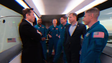 Elon Musk, NASA astronauts Victor Glover, Doug Hurley, Bob Behnken, Mike Hopkins, and NASA Administrator Jim Bridenstine inside the crew access arm with the SpaceX Crew Dragon spacecraft visible behind them during a tour of Launch Complex 39A before a 2019 launch of the Demo-1 mission at the Kennedy Space Center in Florida.