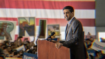 Ro Khanna standing at a podium speaking during a Bernie rally in 2020.