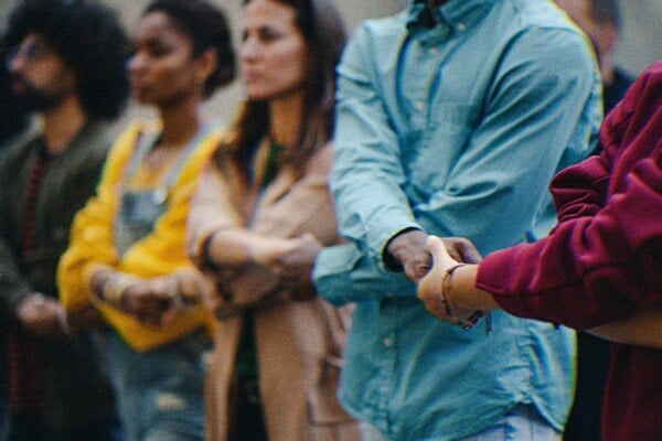 A group of people interlinking hands