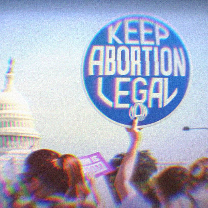 A pro-choice protest at the capitol; the main focus of the image is a sign that says keep abortion legal