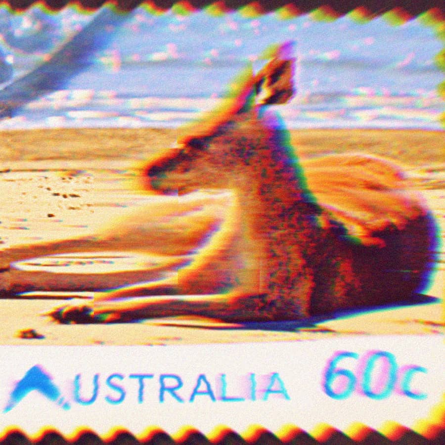 Australian 60c postage stamp depicting a kangaroo laying on the beach