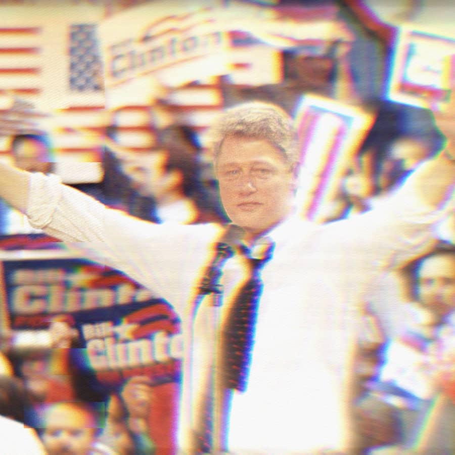 Bill Clinton on the campaign trail in 1992. He's speaking into a microphone, the crowd behind him holds Bill Clinton signs.