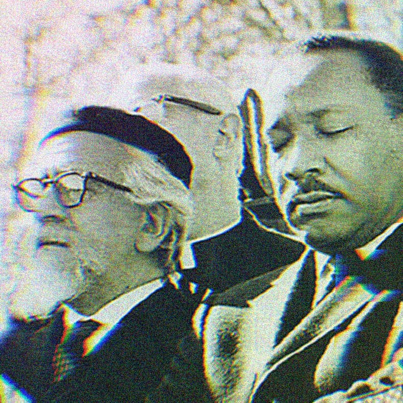 Martin Luther King Jr. and Rabbi Abraham Joshua Heschel walking arm in arm.