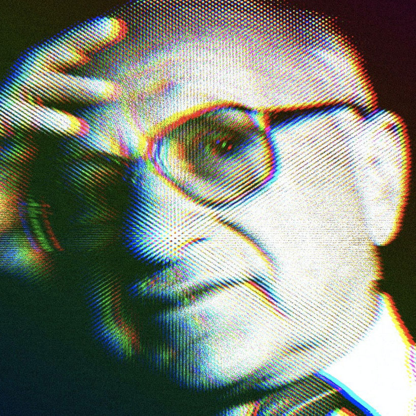 Milton Friedman wearing his signature glasses with his hand resting on his forehead.