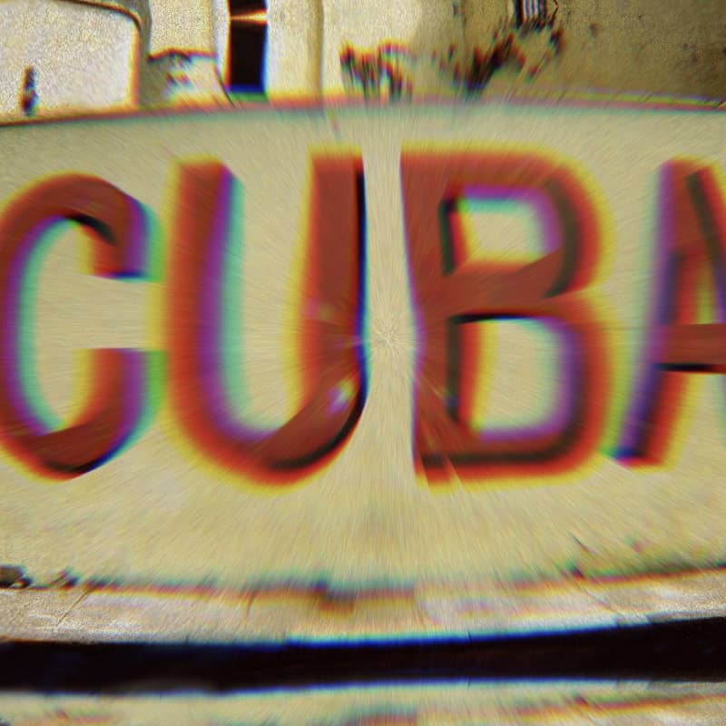 Mural that says “Cuba.” A filter on the photo gives the word Cuba a rainbow glow.