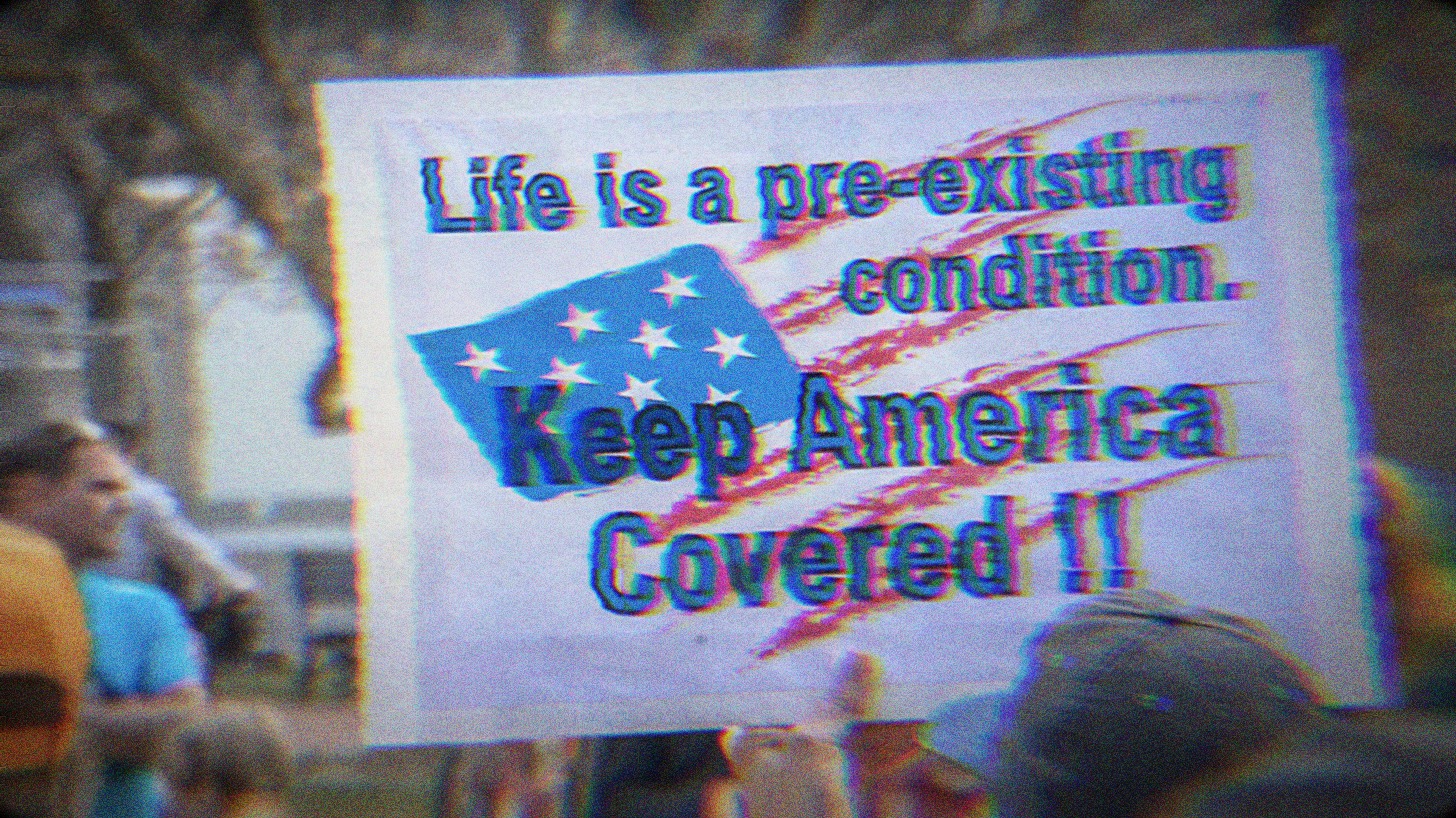 Protest sign that says Life is a pre-existing condition. Keep America covered