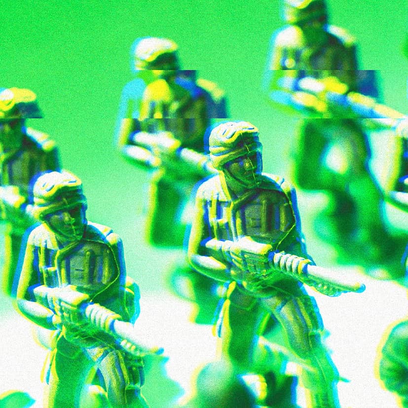 Toy soldiers lined up pointing their guns.