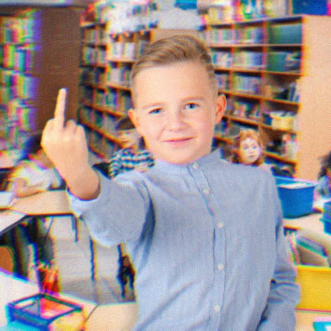 Young student in an art classroom giving the middle finger.