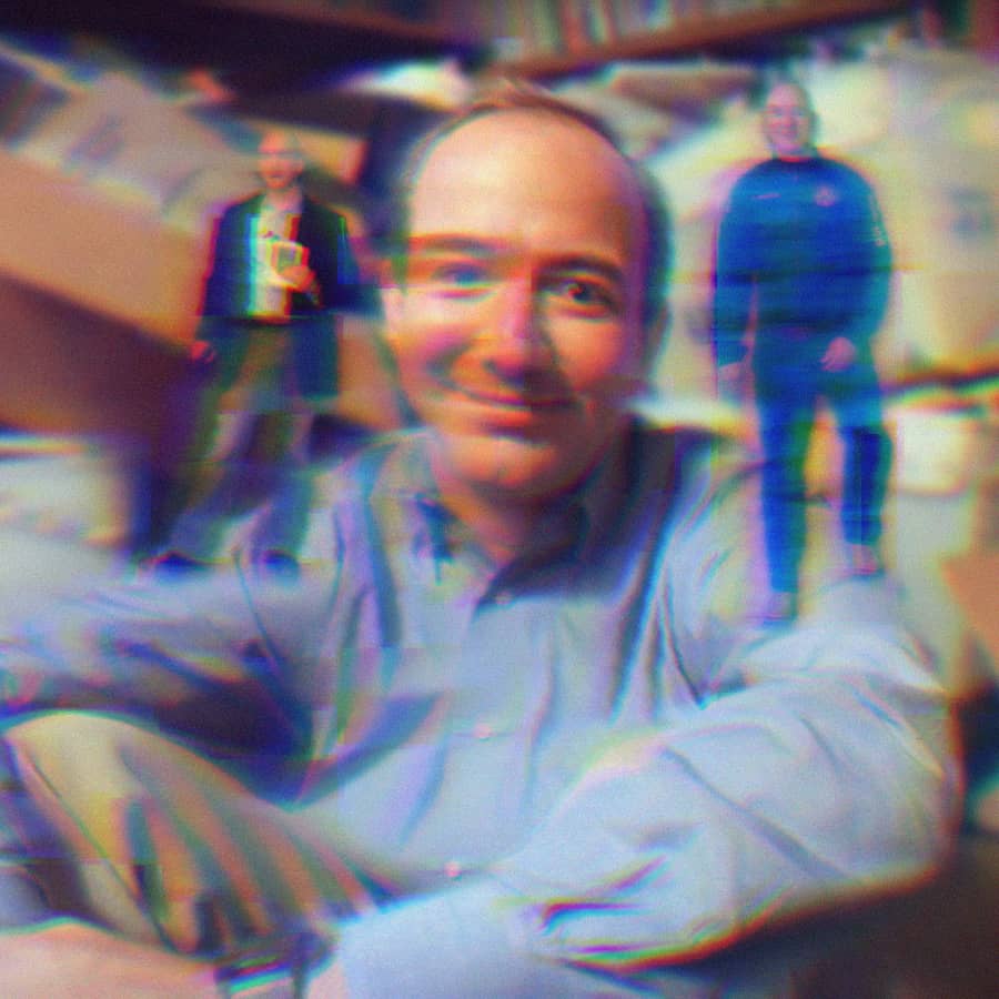 Jeff Bezos from the 90s surrounded by books; on his left shoulder is Jeff Bezos from 2009 holding a Kindle 2 and on his right shoulder is Jeff Bezos from 2021 with his space crew