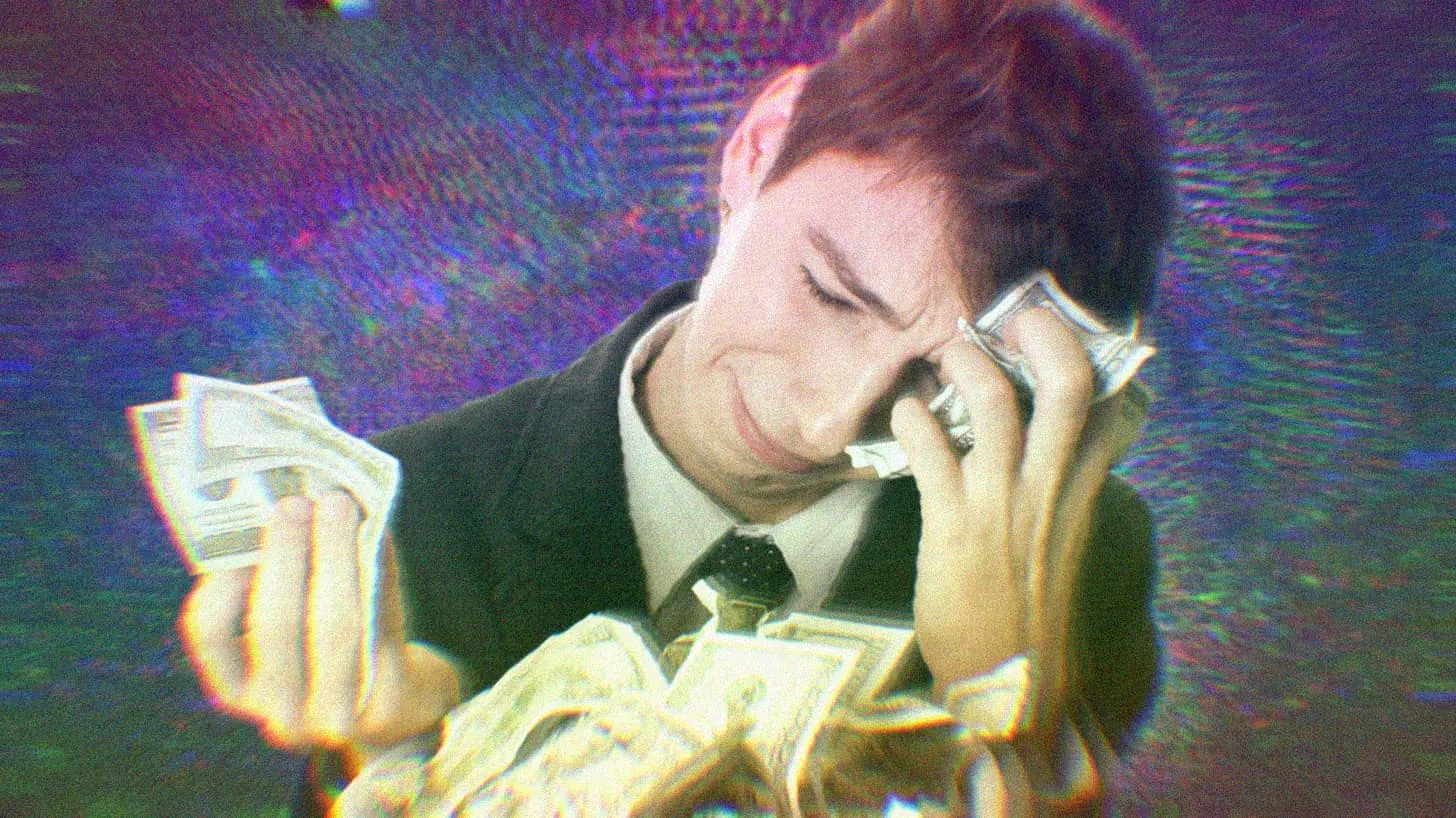 A white male CEO crying into a pile of $100 bills.