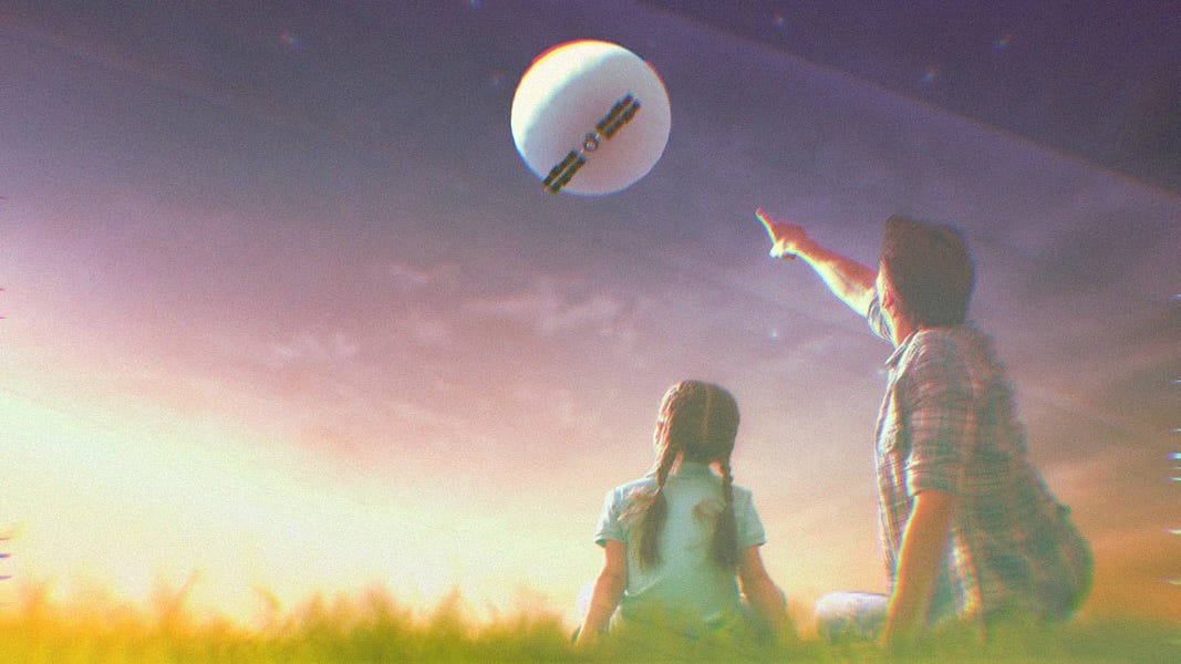 A father and daughter sitting on the grass at night. The dad is pointing at the spy balloon in the sky.