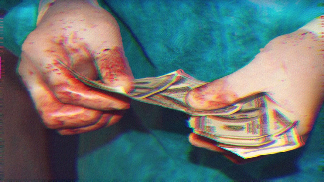 A healthcare professional wearing scrubs and rubber gloves is counting a stack of $100 bills. The rubber gloves have blood on them.