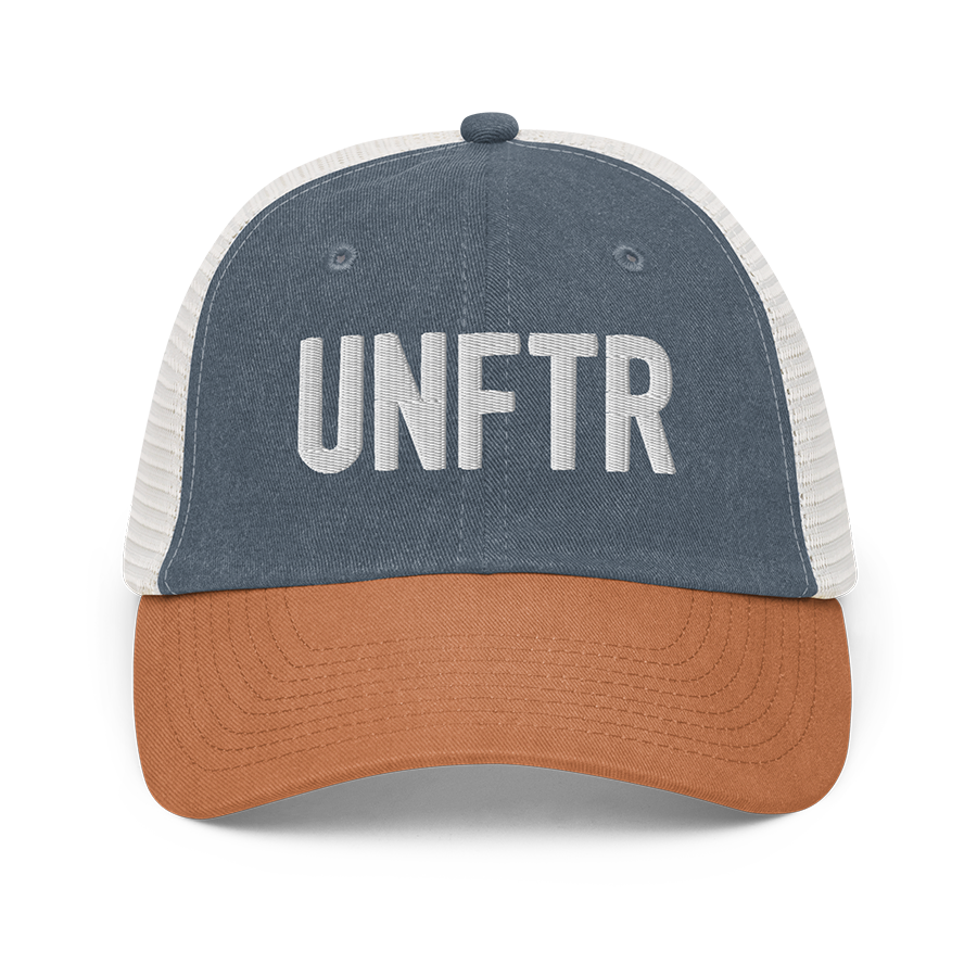 Blue, orange and white trucker hat with white embroidered logo that says UNFTR.