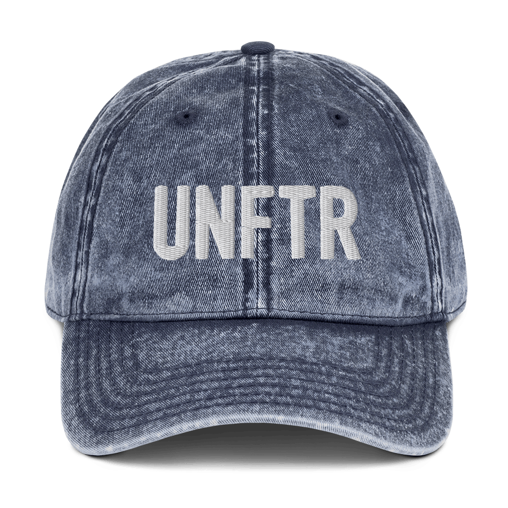 Denim-like vintage wash dad cap with white UNFTR logo embroidered on the front. 